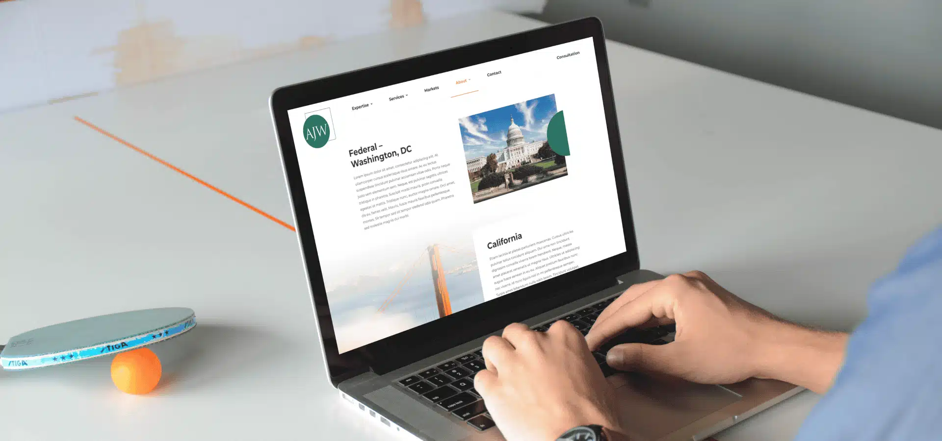 AJW web design mockup on a laptop